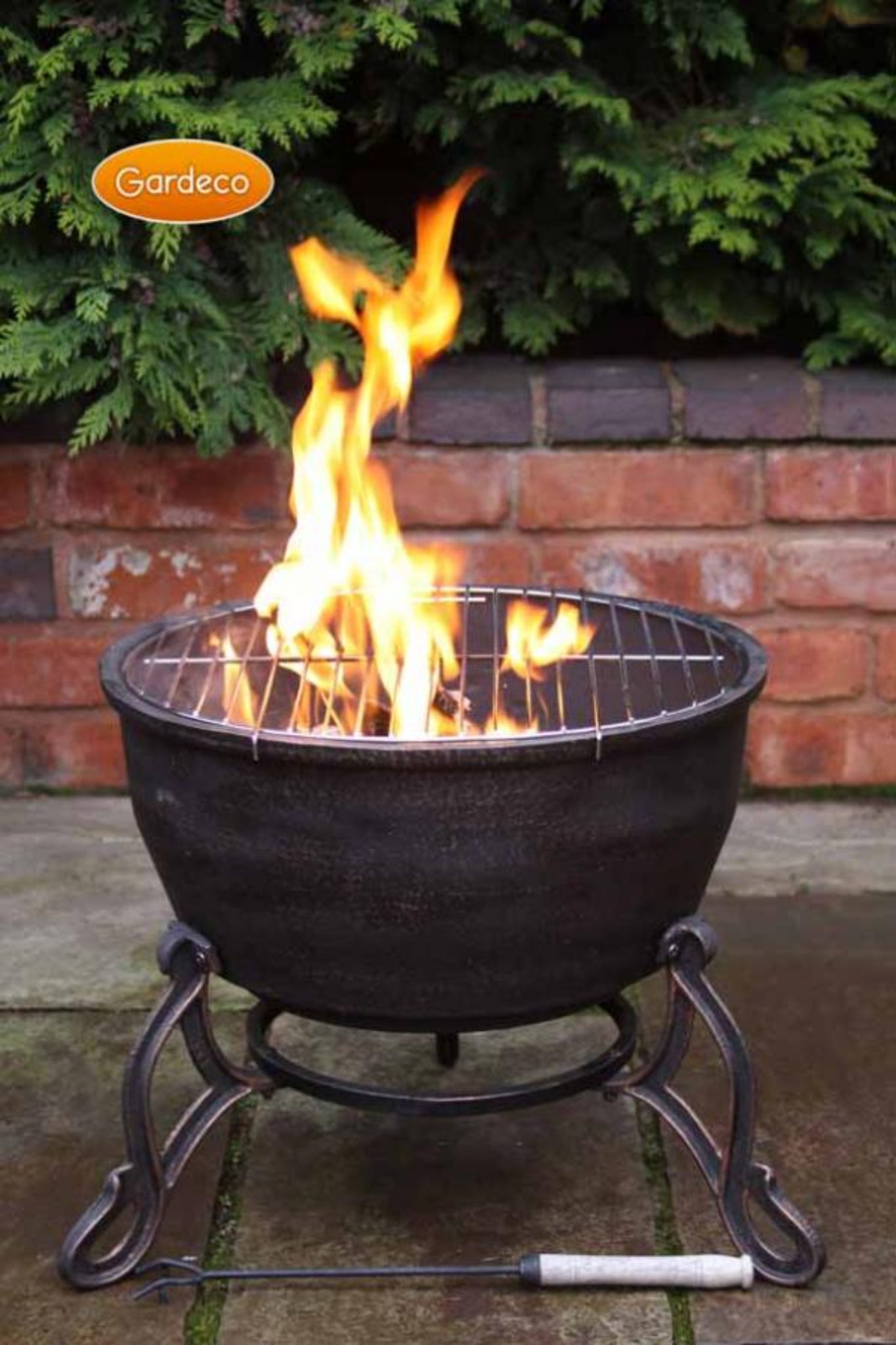 Fire pit with flames on a patio, featuring the Gardesco brand.