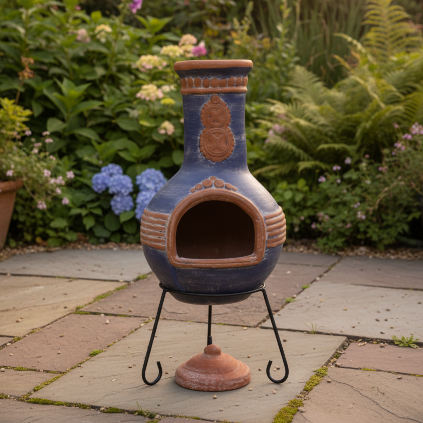 Extra-large_Azteca_Mex_chimenea_in_blue_and_orange on a patio