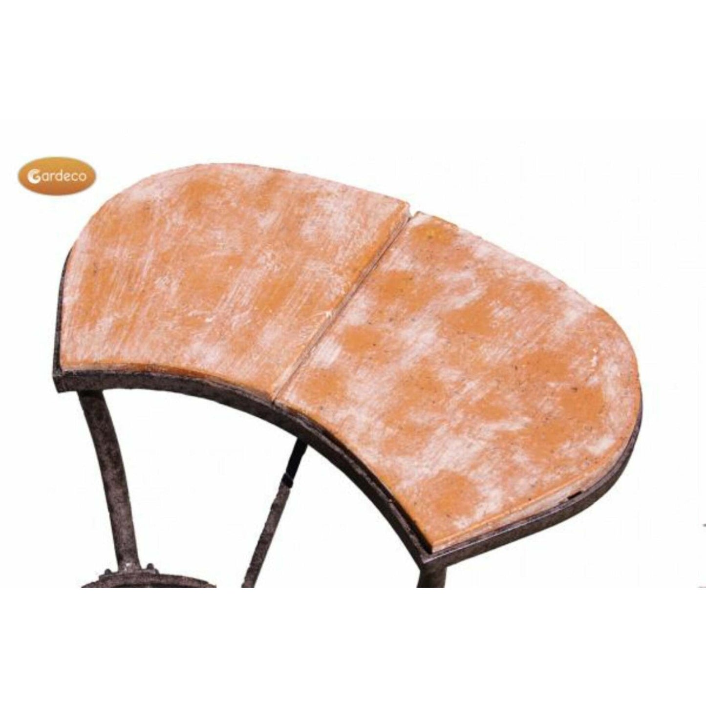 A close-up of a curved wooden tabletop with a distressed orange-brown finish and dark metal legs, shown against a plain white background. A small 'Gardeco' logo appears in the top-left corner.