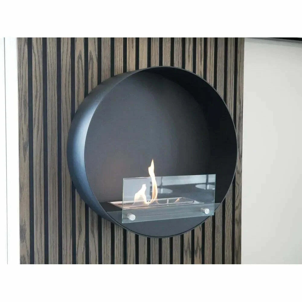 Modern wall-mounted fireplace with a circular design against a striped wall.