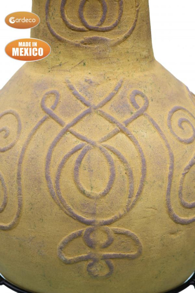 Close up of chiminea with intricate patterns, made in Mexico, on a white background.