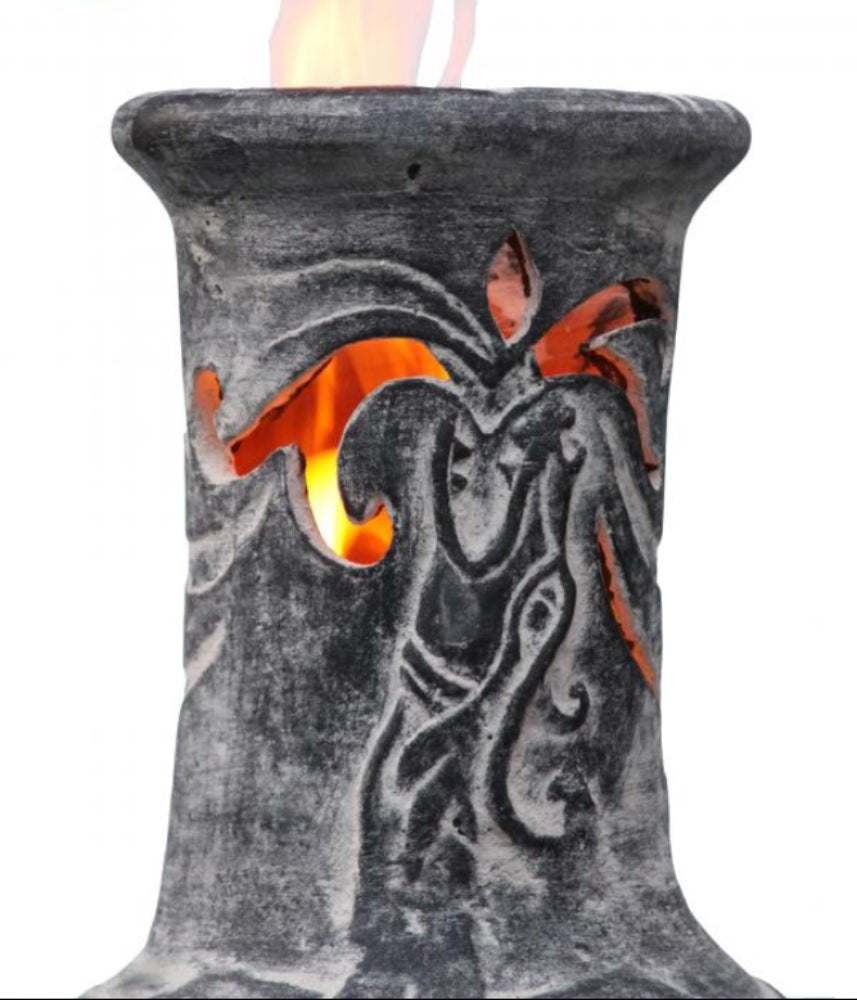 Decorative chiminea with dragon design and visible flame, made in Mexico.
