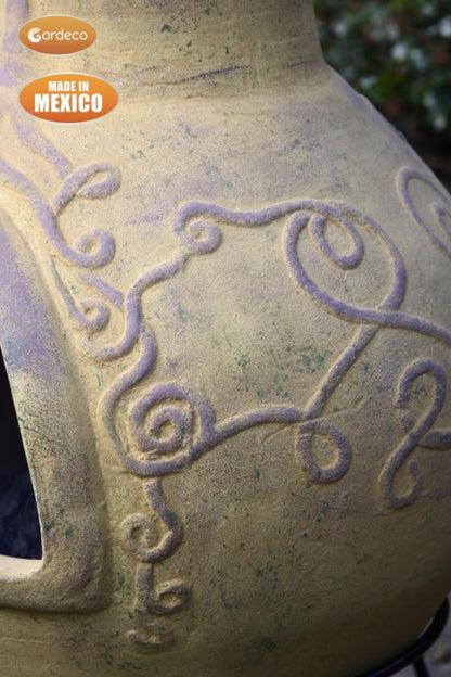 Derwyn The Tree Mexican Chiminea – Charcoal with Tree Design - Mustard showing  intricate designs and 'Made in Mexico' label on a blurred background