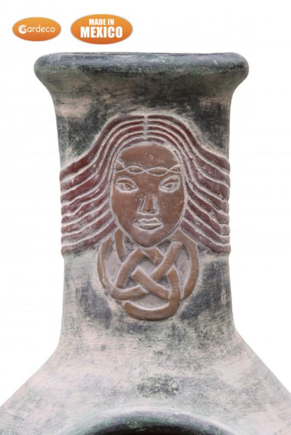 Ceramic chiminea close up of face design and 'Made in Mexico' label on a white background