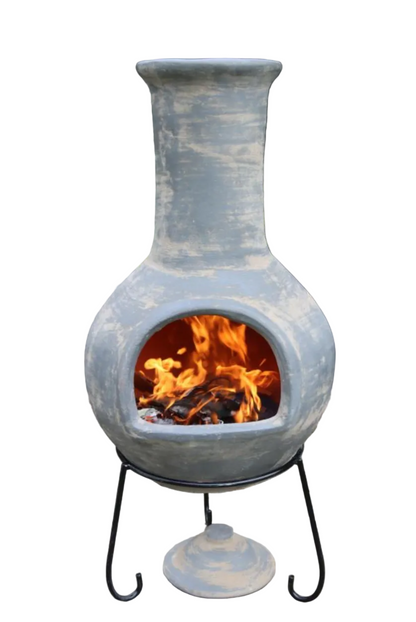 Ceramic chiminea with flames inside on a white background