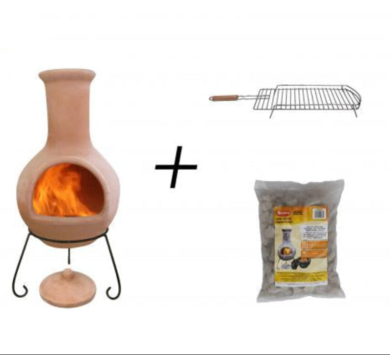 A Ceramico-style chimenea fireplace insert with a visible orange flame, shown on a white background alongside a metal grill rack and a bag of lava stones. 
