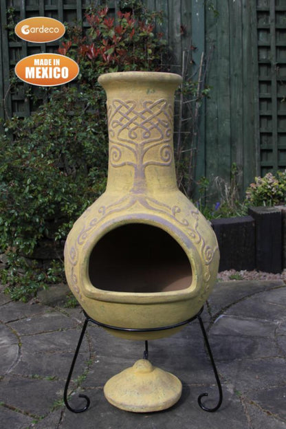 Decorative outdoor fireplace with intricate design on a stone patio, made in Mexico by Gardeco.