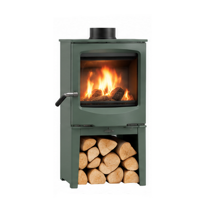 A small dark green wood-burning stove with a visible fire inside the glass front and a stack of cut logs in the lower shelf, shown on a plain white background with text labels above and below.