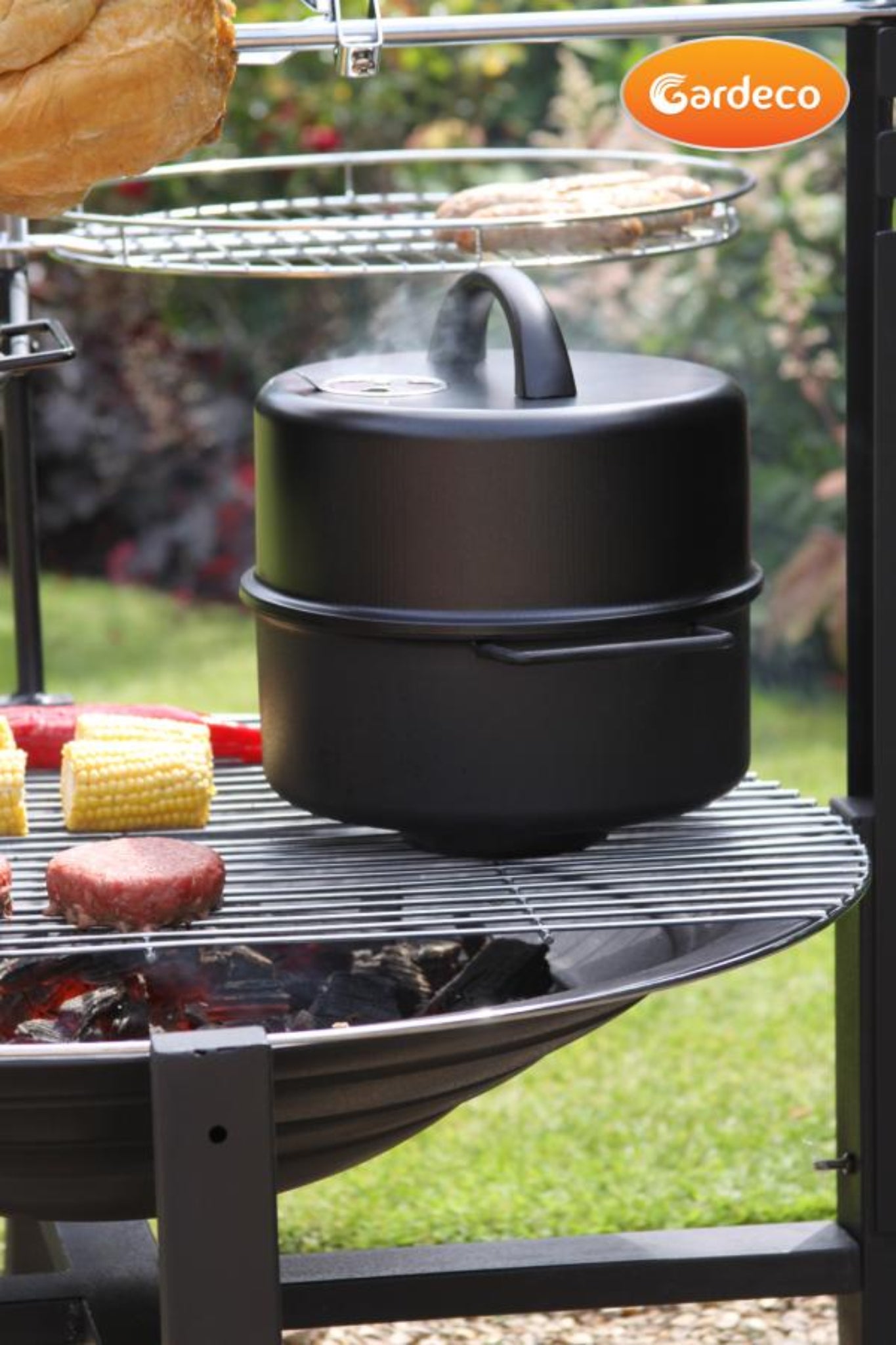 Black food smoker on a grill with Gardeco branding in an outdoor setting.
