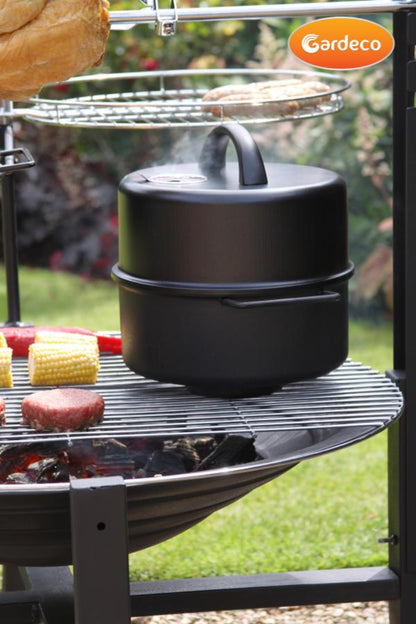 Black food smoker on a grill with Gardeco branding in an outdoor setting.