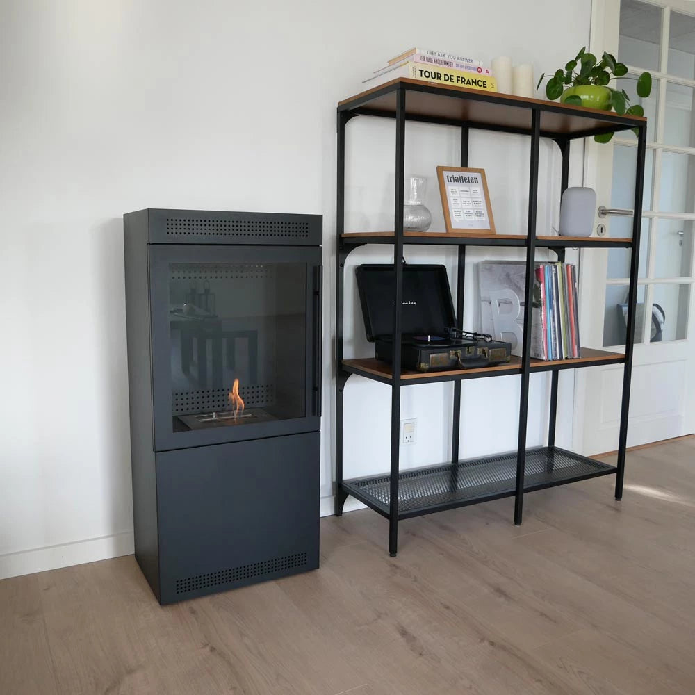 Modern fireplace next to a bookshelf with decorative items in a room.