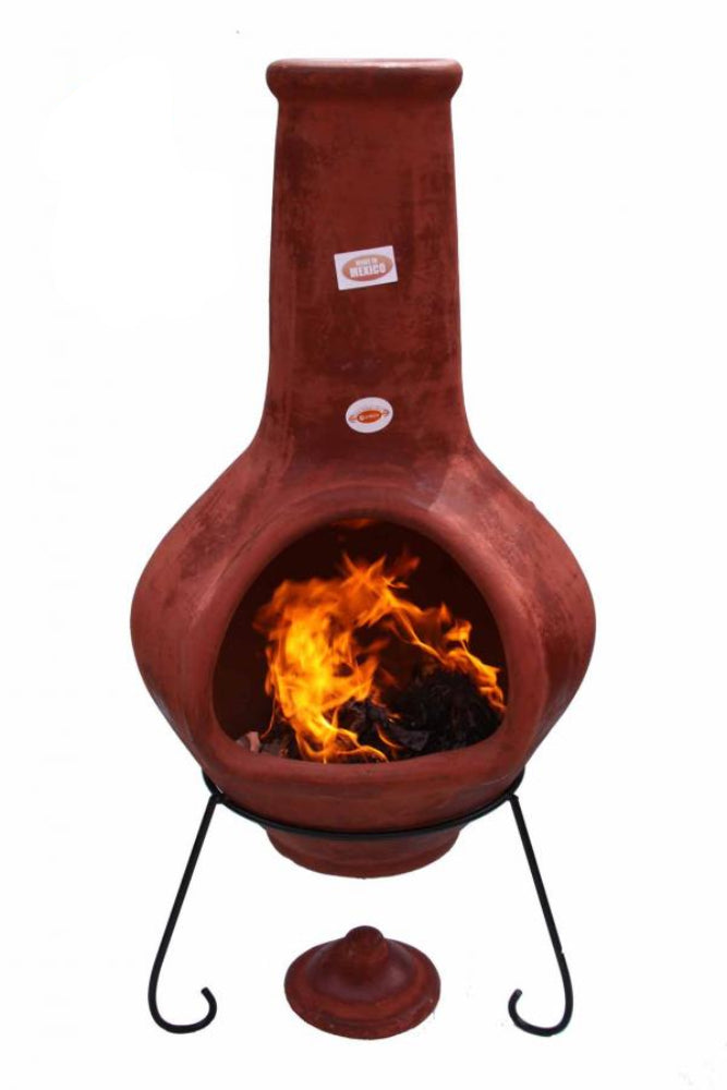 Terracotta chiminea with fire burning inside, made in Mexico, on a white background