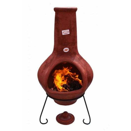 Terracotta chiminea with fire burning inside, made in Mexico, on a white background