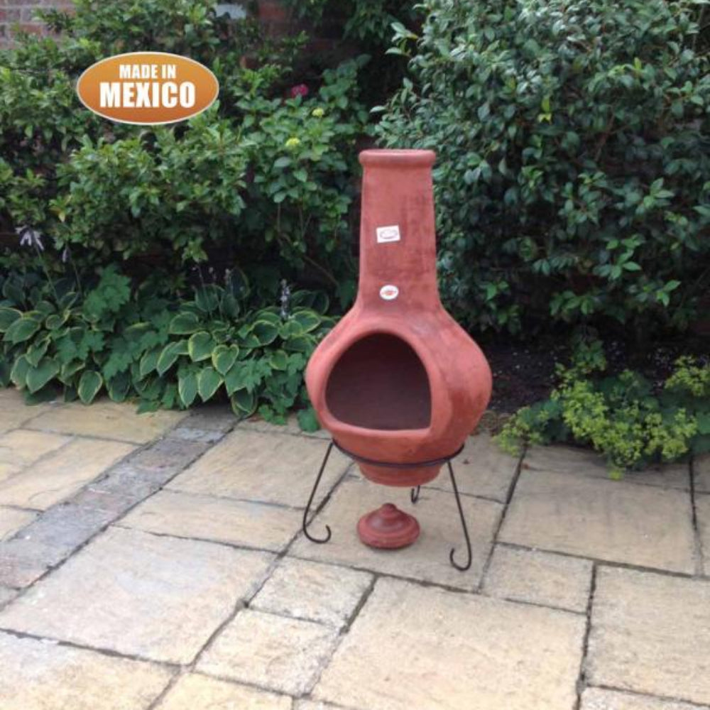 Terracotta chiminea on a patio with greenery in the background, featuring Gardeco branding.