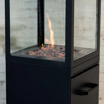Modern outdoor fireplace with glass doors on a concrete wall background