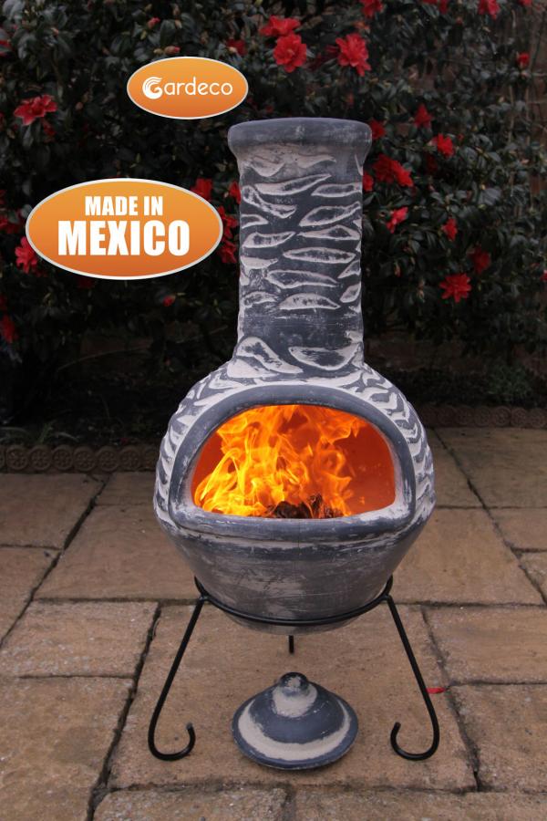 Ceramic chiminea with flames on a patio, featuring Gardeco branding.