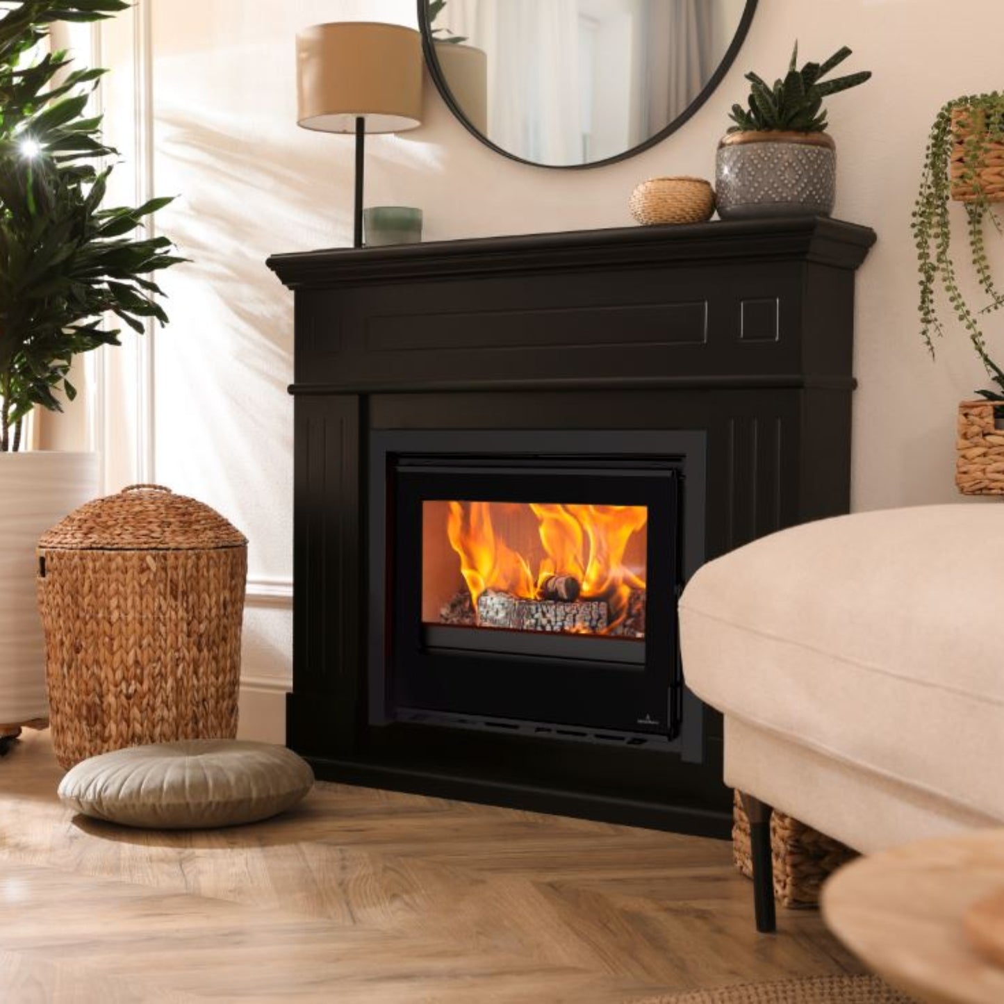 Living room with an Opus Octave 70i stove in black surround with , plants, and a white sofa.