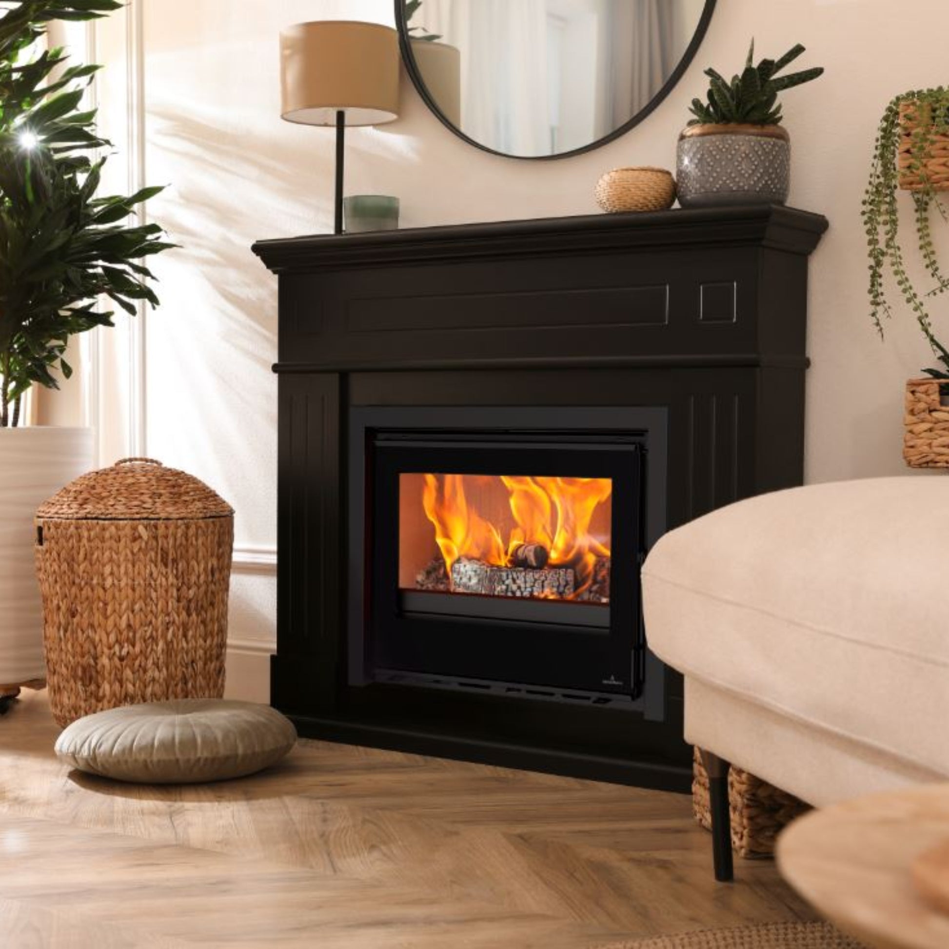 Living room with an Opus Octave 70i stove in black surround with , plants, and a white sofa.