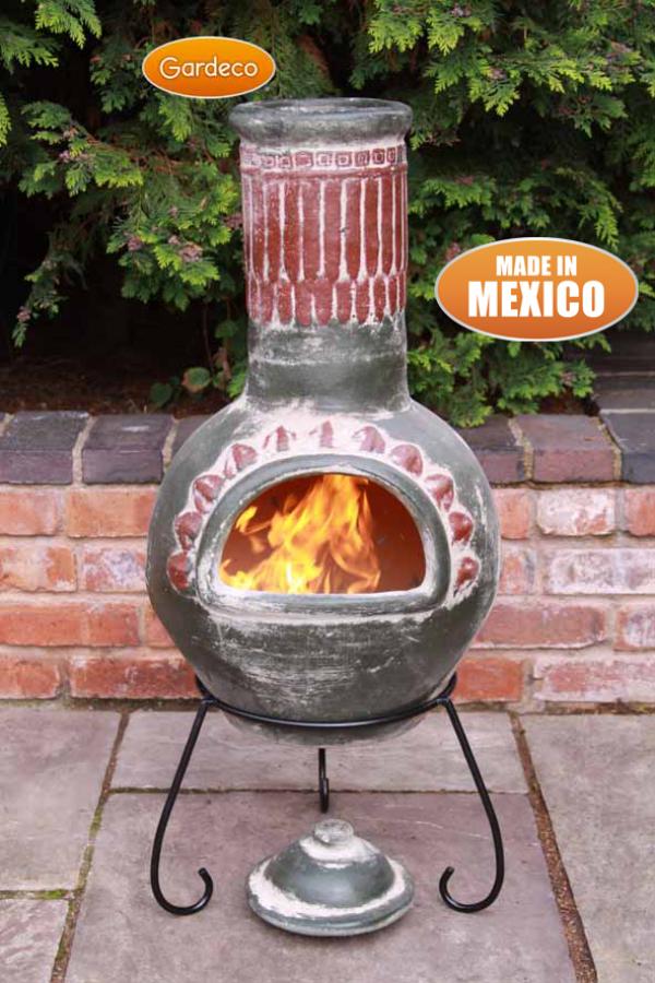 Decorative outdoor fireplace with flames, made in Mexico, on a patio.