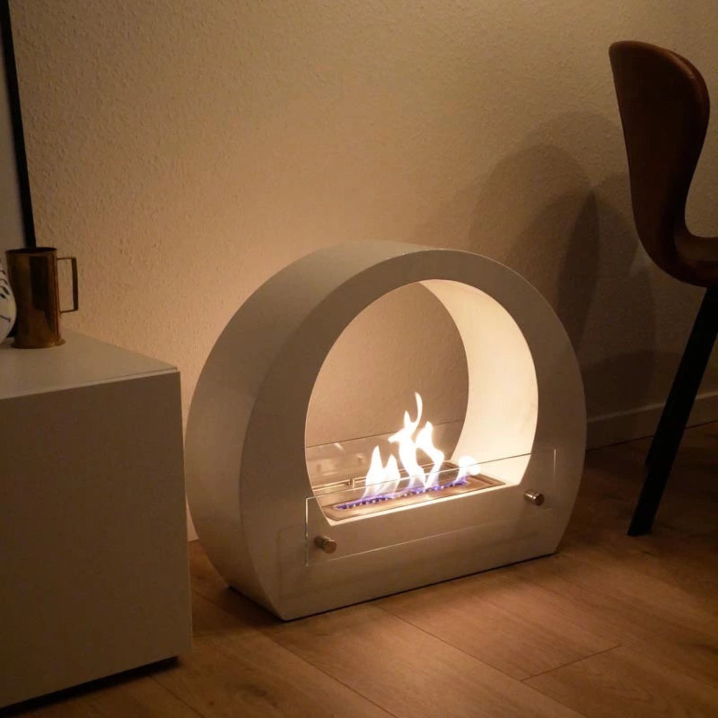 ScandiFlames Dallas Bio Fireplace with Arch – White, with flames on a wooden floor.