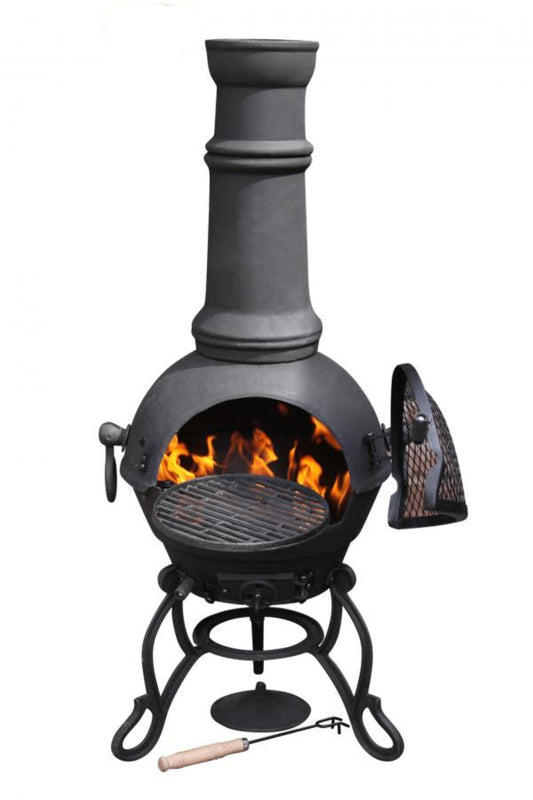 Black cast iron chiminea with flames inside on a white background.
