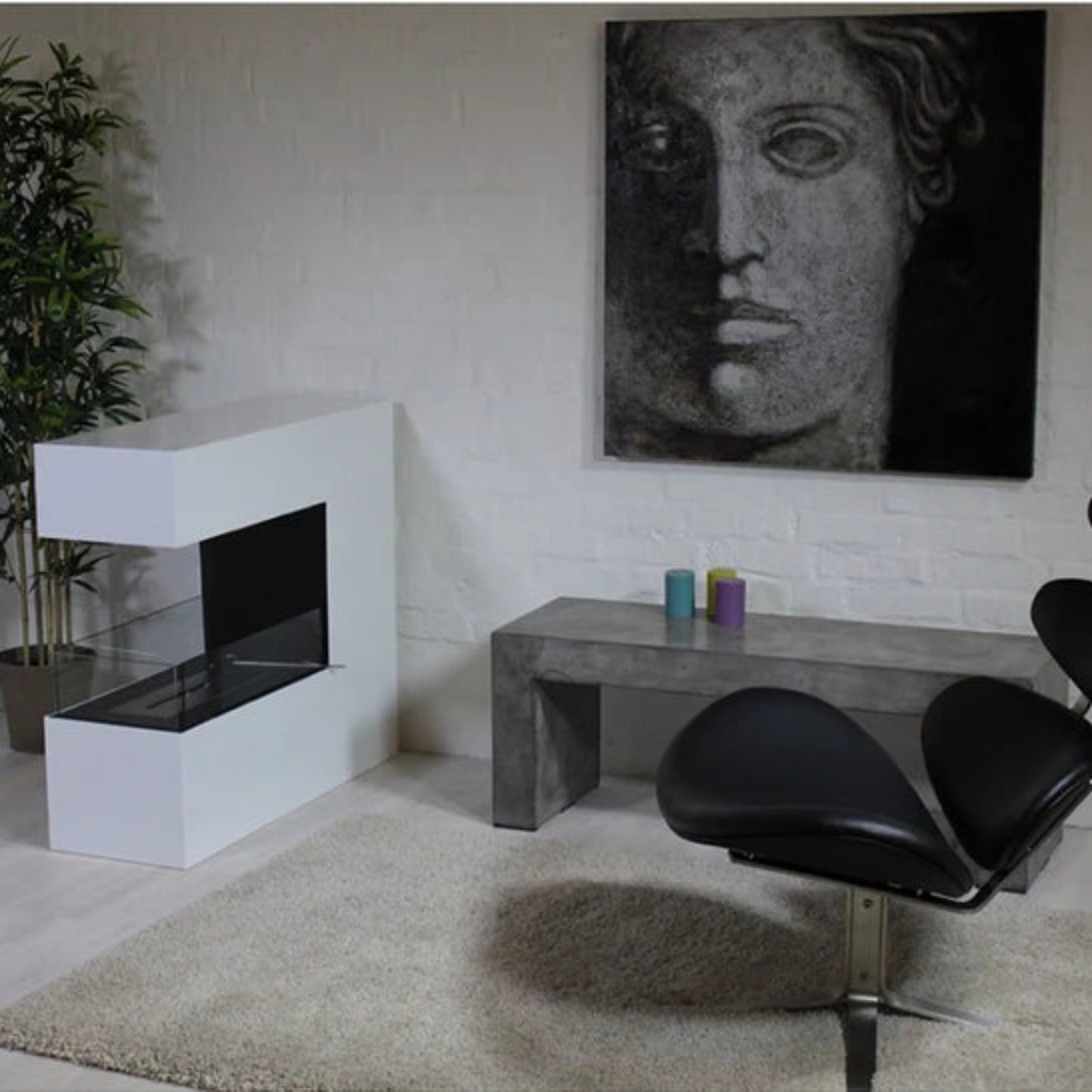 Modern interior with a black chair, white fireplace, and abstract painting on a light-colored wall.