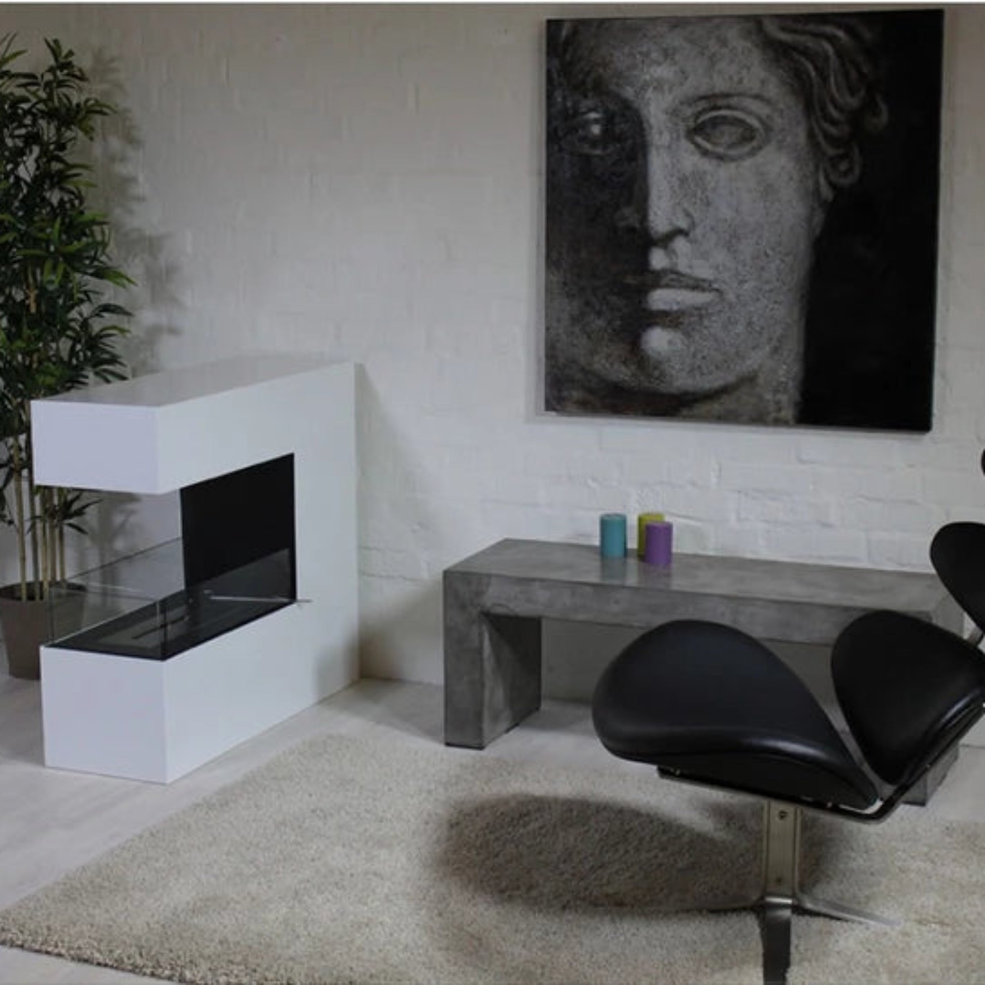 Modern interior with a black chair, white fireplace, and abstract painting on a light-colored wall.