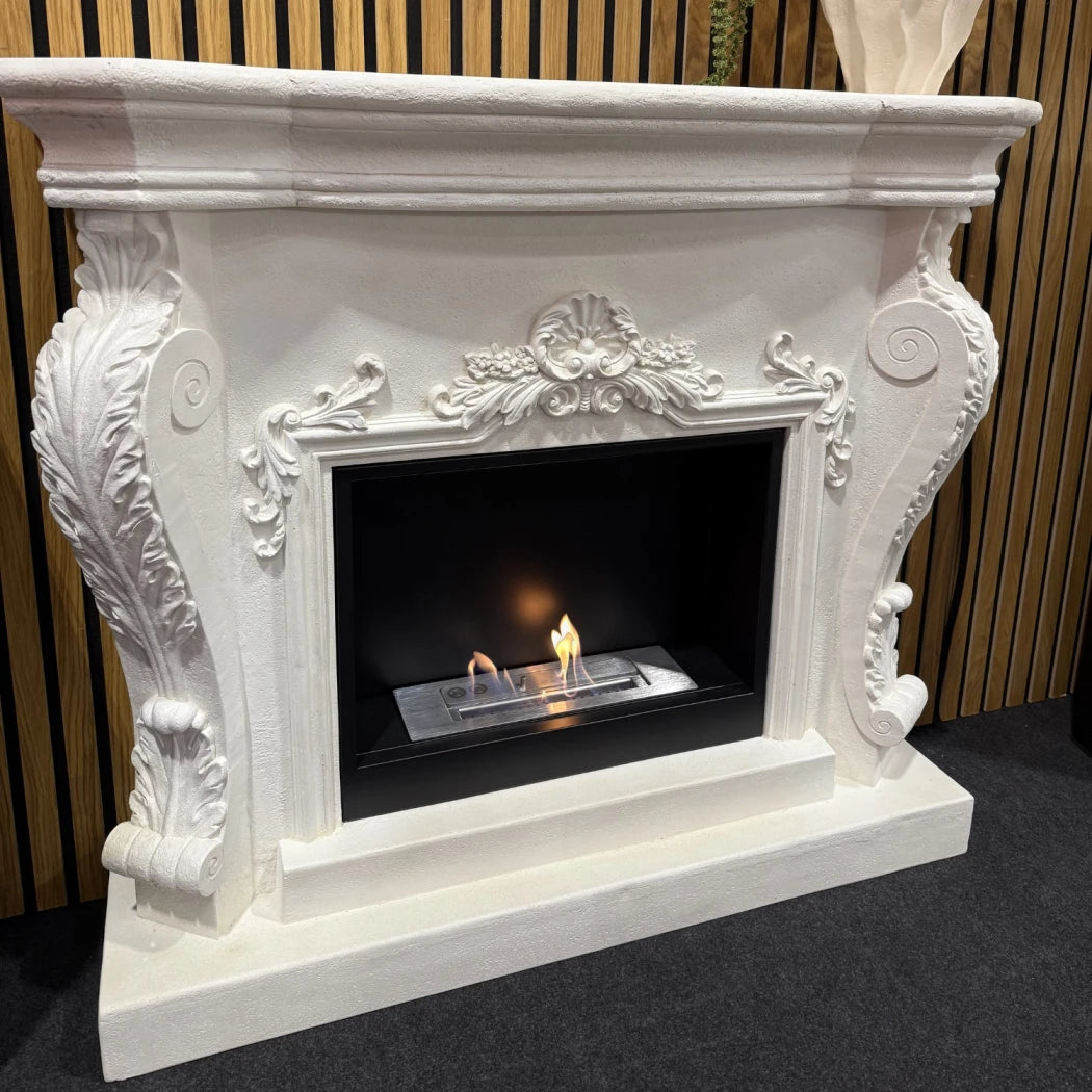 Decorative white fireplace with a lit fire inside, set against a striped wall.