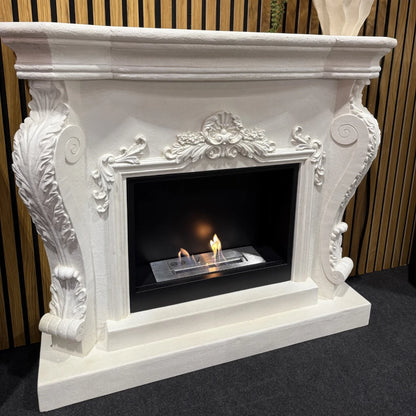 Decorative white fireplace with a lit fire inside, set against a striped wall.