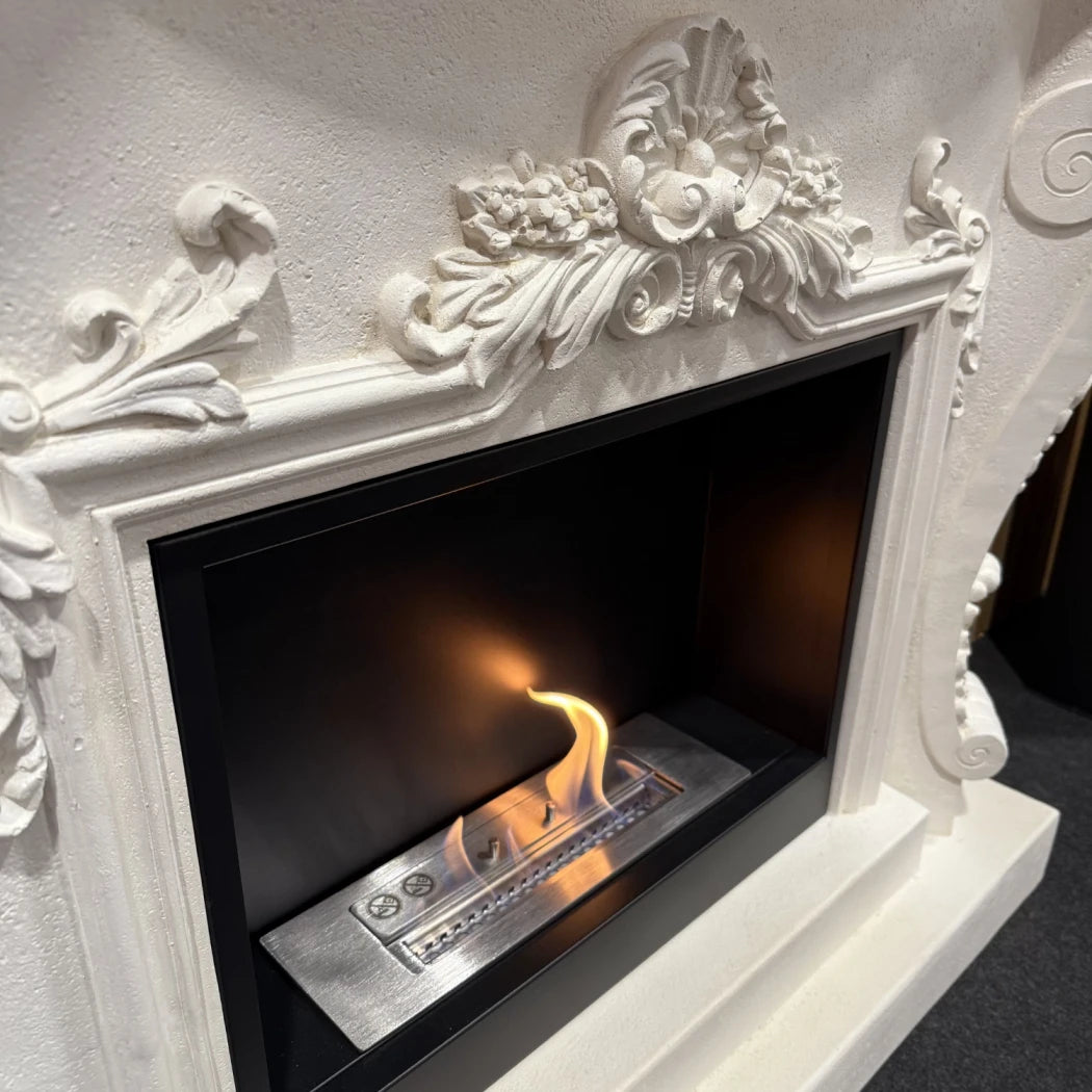 Decorative white fireplace with a burning fire inside