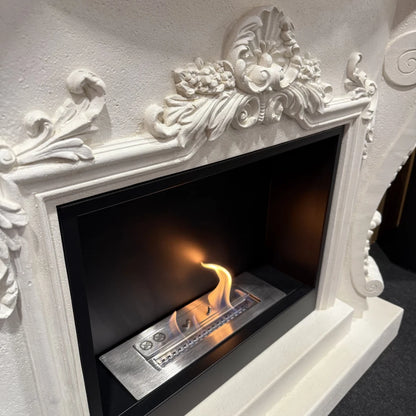 Decorative white fireplace with a burning fire inside