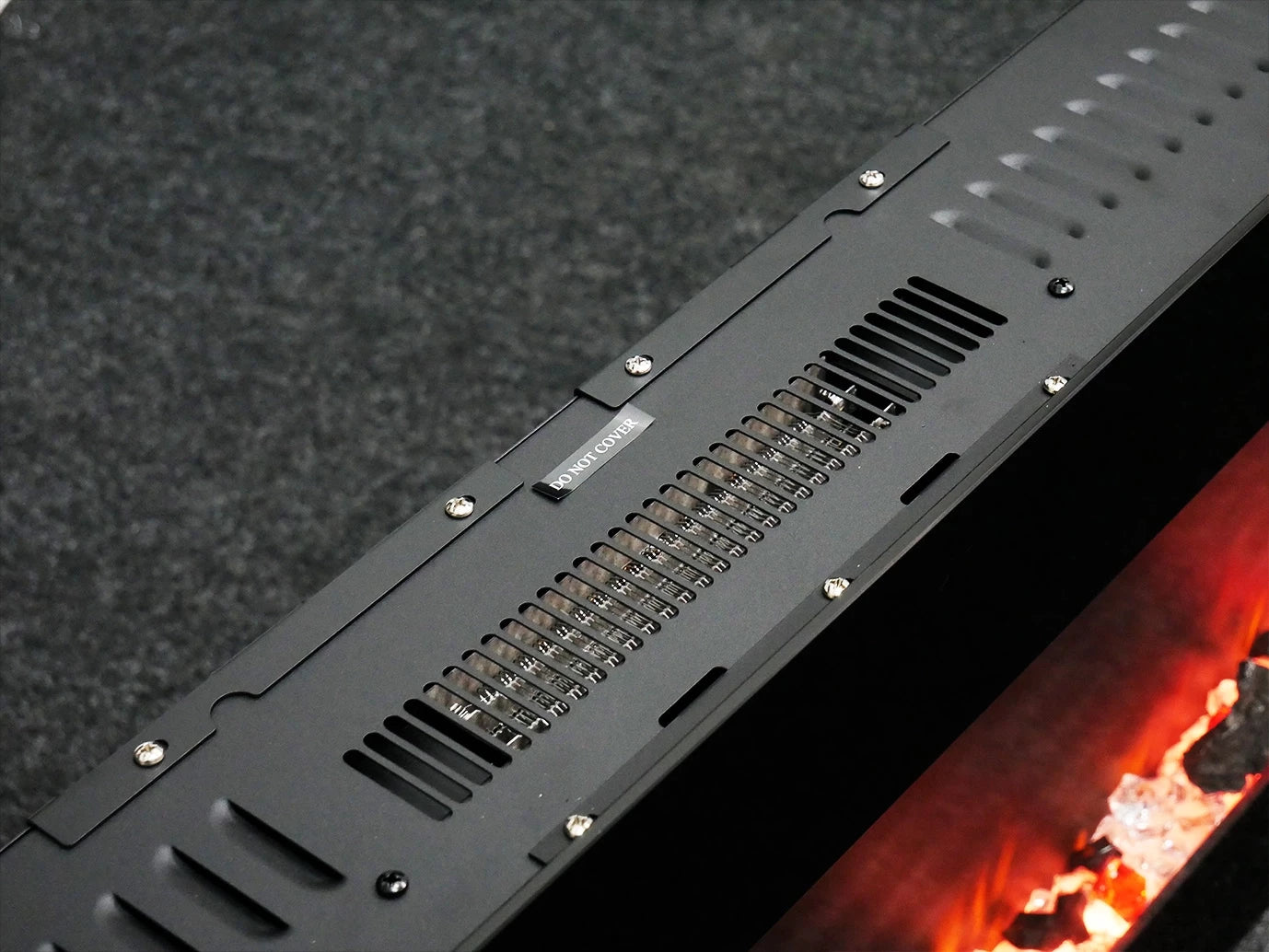 Black metal strip with ventilation holes on a textured surface