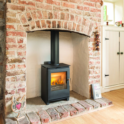 Beltane Brue 4kW stove in a traditional brick fireplace