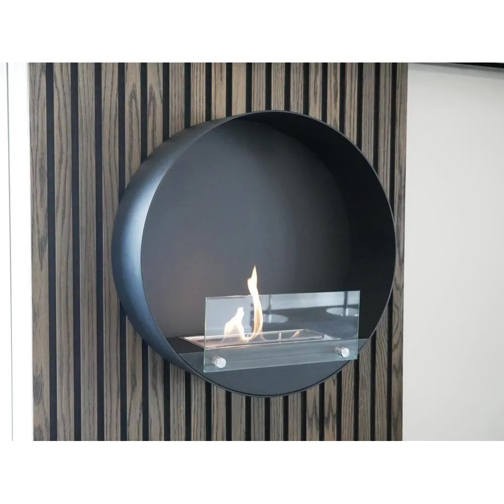 Modern wall-mounted fireplace with a circular design against a striped wall.