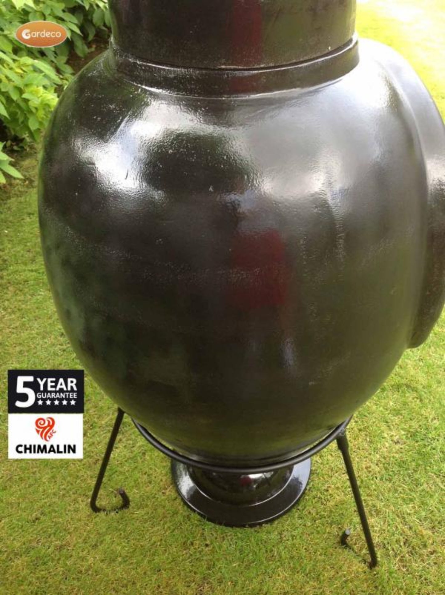 Close up ofBlack chimenea on a grassy background with 'Chimalin' branding.
