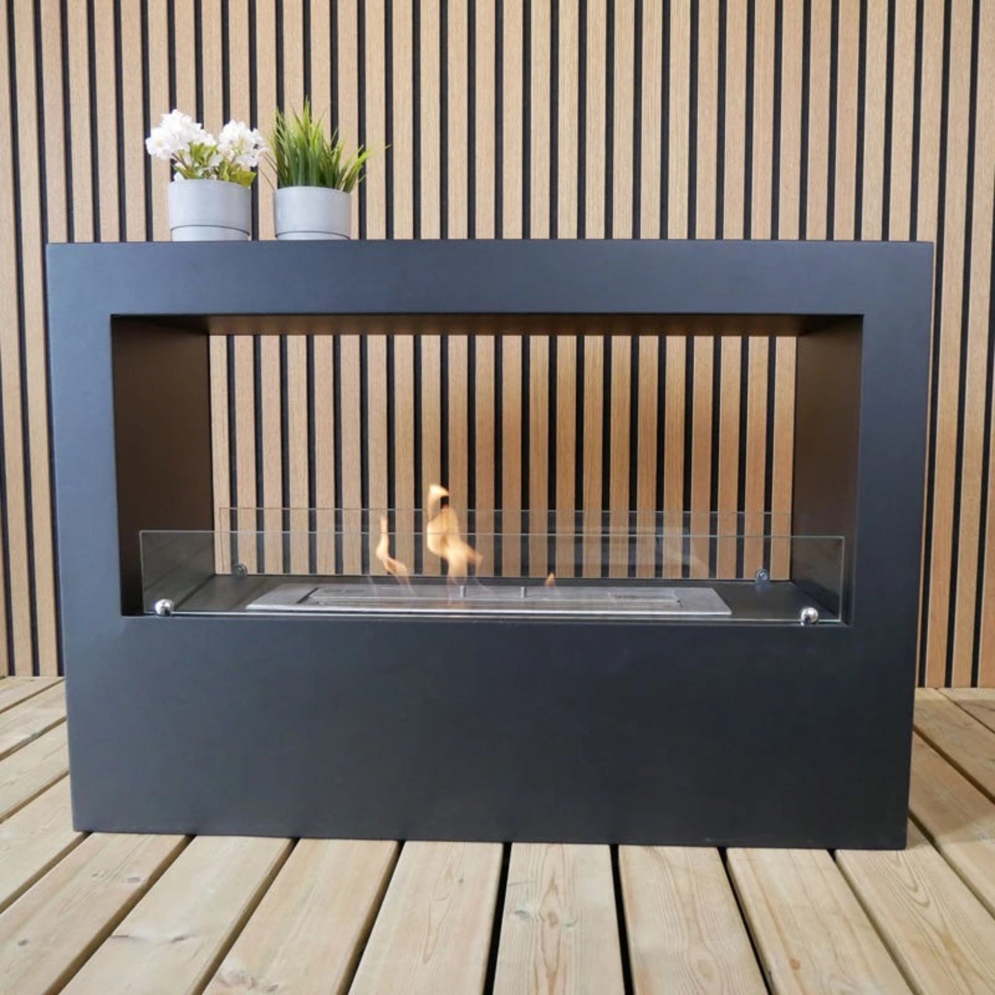 Modern outdoor fireplace with a wooden background