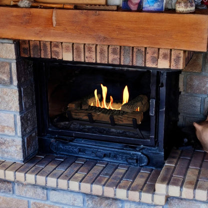 Brick fireplace with ScandiFlames 40cm Bioethanol Fire Grate burning inside and wooden mantel above.