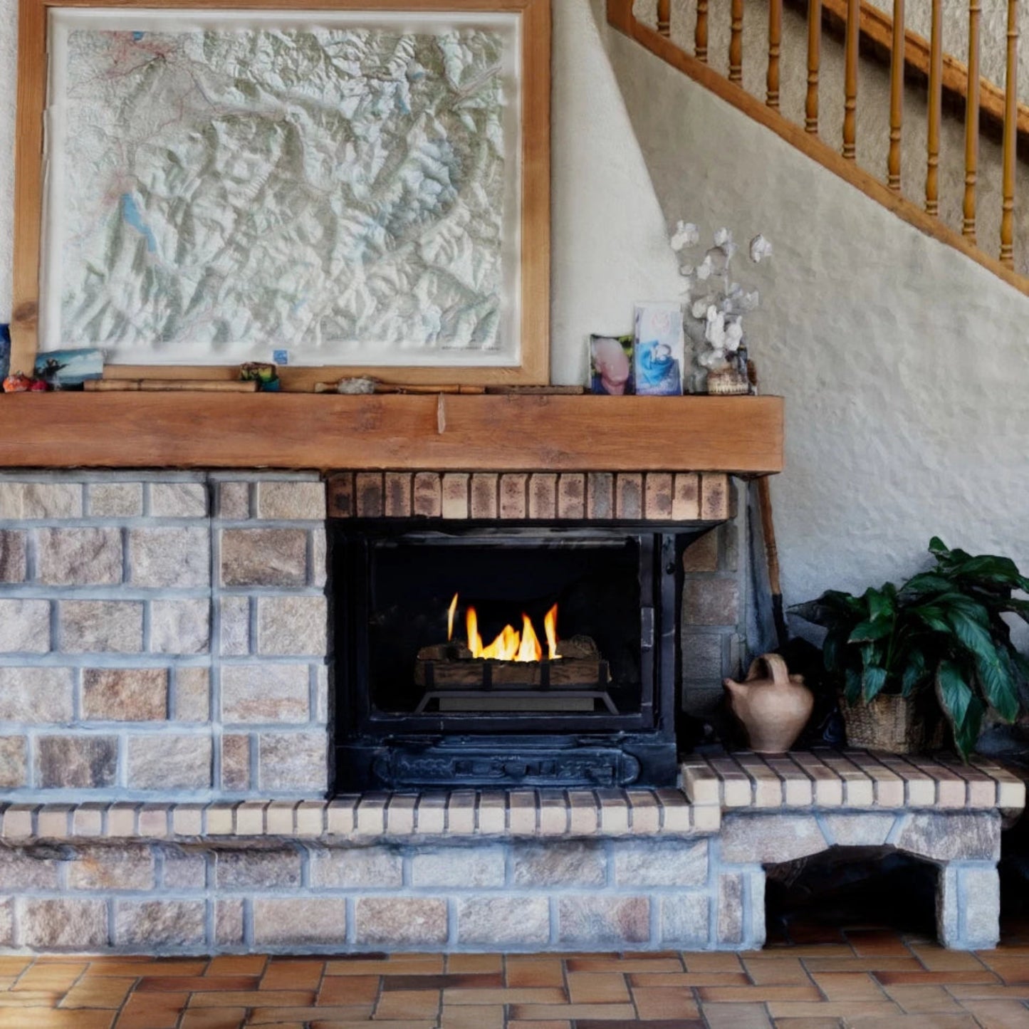 Brick fireplace with ScandiFlames 40cm Bioethanol Fire Grate with wooden mantel and framed artwork above it.