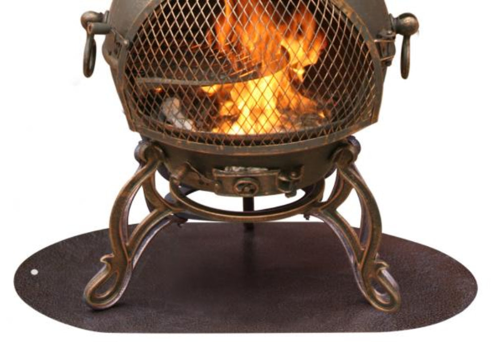 An antique-style metal fire pit with a mesh screen and glowing orange flames inside, supported by ornate legs and sitting on an oval dark base against a white background.