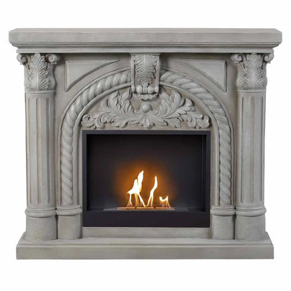 Decorative fireplace with intricate carvings and a small fire inside.