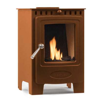 A brown cast iron wood-burning stove with a glass front door showing a lit fire, a silver metal handle, and a small recessed HEMEL logo on the lower front, isolated on a white background.